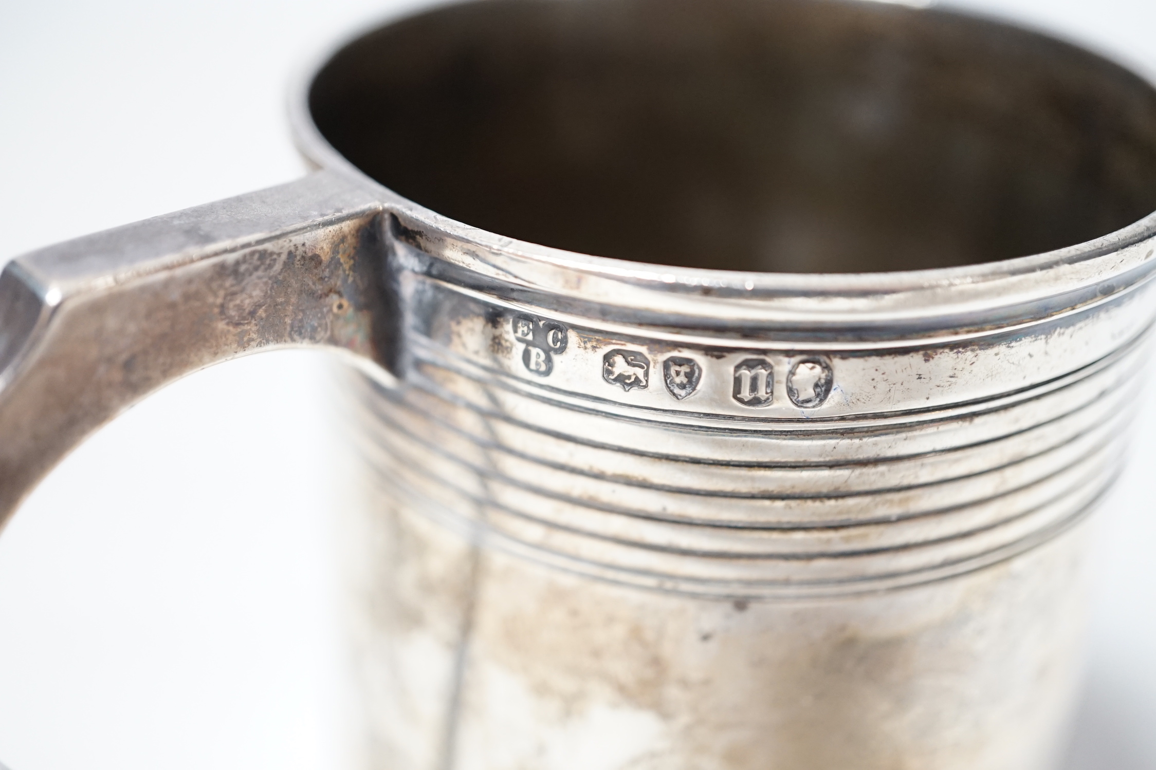 A Victorian reeded silver christening mug, Edward Charles Brown, London, 1868, 94mm.